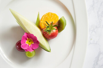 Melon slices and fruits on a plate