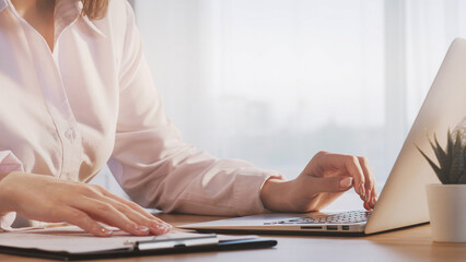 Secretary work. Office job. Woman employee hands typing on keyboard keeping records on corporate...