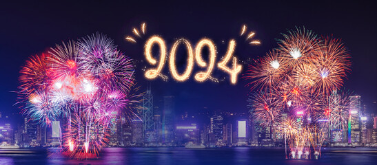 Happy new year 2024 firework over cityscape building near sea at night time celebration