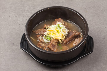 A soup made by boiling the head, intestines, bones, feet, and crucible of a cow. Or food cooked in the soup.