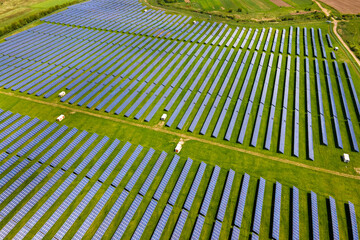 Aerial view of big sustainable electric power plant with many rows of solar photovoltaic panels for producing clean ecological electrical energy. Renewable electricity with zero emission concept
