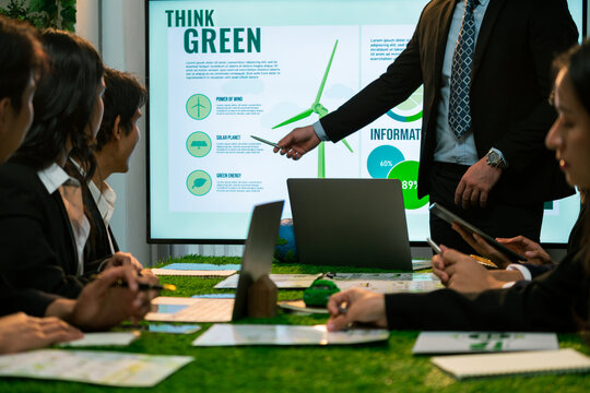 Businessman leader give presentation on eco-friendly implementation in order to reduce CO2 emission and make sustainable ecology for greener future with renewable alternative energy technology. Quaint