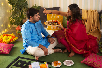 Sister performing rituals on the occasion of Raksha Bandhan 