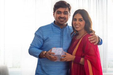 Portrait of happy sibling sharing gift on Rashabandhan