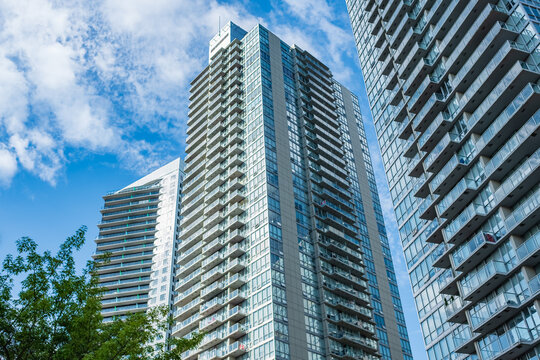 New block of modern apartments with balconies and blue sky in the background. View of an apartment complex in Surrey BC