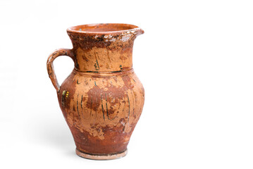 Antique earthenware jug with damaged paint on the surface.