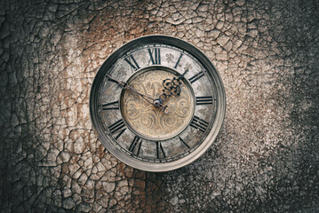 Vintage clock on an old cracked background