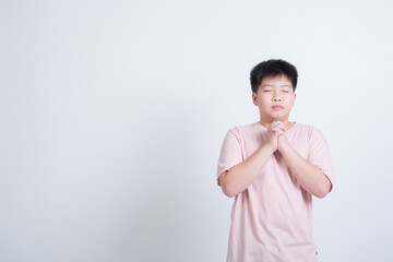 boy praying on white background