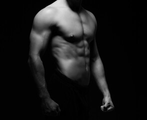 Strong, fit and sporty bodybuilder man over black background