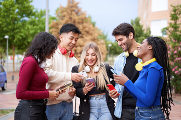 Group of friends having fun with content they see on their mobile phones. . Friendship and technology concept.