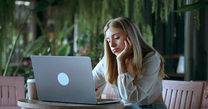 Young beautiful blonde woman business worker stressed working at cafe, concept professional development. Woman is swamped with work and feels boredom and sadness professional development.