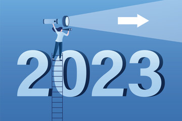 Economic prospects in 2023. Visionary illuminates future with flashlight. Businesswoman climbing stairs to look through binoculars at number 2023. Business opportunities and targets or goals.