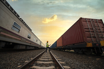 Fototapeta premium Engineer inspects container train of transport company Distribution and transportation of goods by rail A container train passing through an industrial area