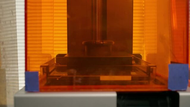 3D printer device used for manufacturing of the artificial teeth replacements. 3D printer device making the dental restorations at the lab. 3D printer device producing the stomatology treatments.