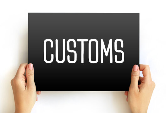 Customs - authority or agency in a country responsible for collecting tariffs and for controlling the flow of goods, text concept on card