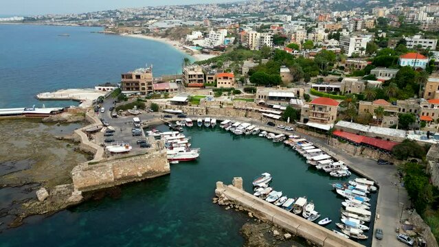 Drone shot Byblos Port in Lebanon. Ships docked in Mediterranean Sea