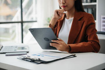Working Process in Modern Office. Young Woman Account Manager Working at Table with New Business Project. ,Using Contemporary Laptop.