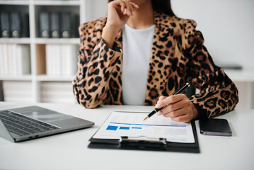 Working Process in Modern Office. Young Woman Account Manager Working at Table with New Business Project. ,Using Contemporary Laptop.