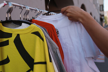 Close-up of woman thrifting at vintage clothing shop