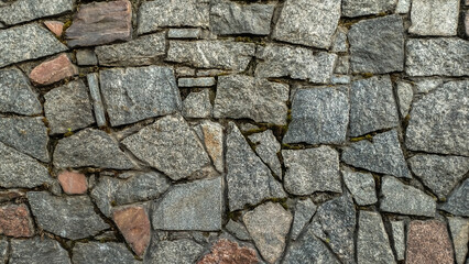 A stone wall made of rocks and gravel