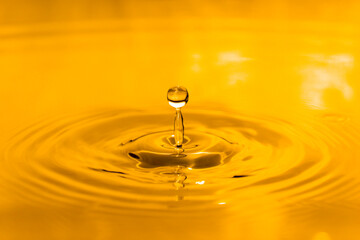 yellow drop oil , Liquid gold oil drop ripple background.