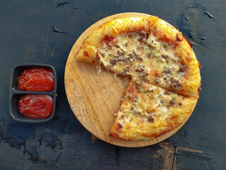 Mouthwatering pizza and tomato sauce at the table