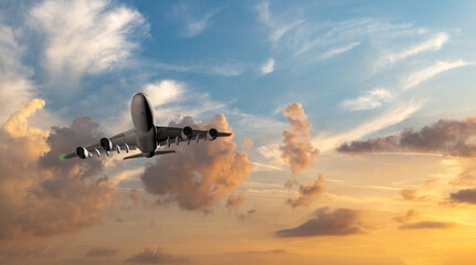 Passenger commercial aircraft flying above the clouds in sunset light.