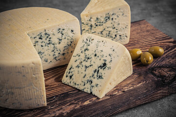 Cheese collection, piece of gorgonzola cheese with blue mold close up - 624280749