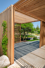 Fototapeta Modern wooden arbor. Modern wooden gazebo in courtyard, backyard obraz
