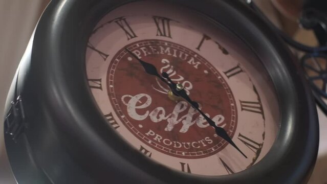 City old street clock next to coffee close-up