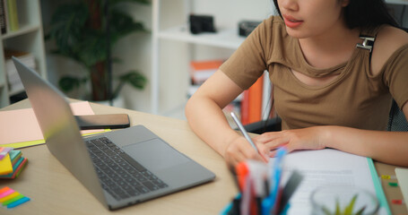 Young Asian woman working with a laptop on a desk