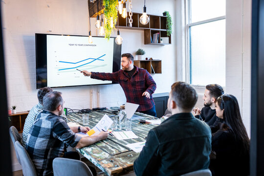Businessman giving presentation and having meet in office with colleagues