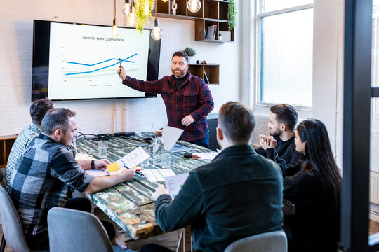 Businessman giving presentation and having meet with colleagues