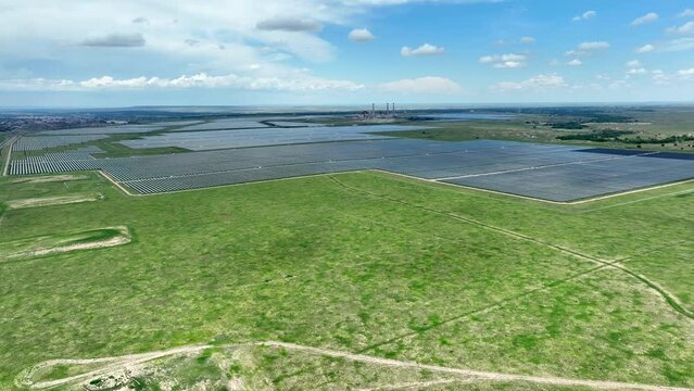 Wide shot of huge solar farm. Aerial establishing shot of solar arrays providing clean, renewable, and green energy for American cities.