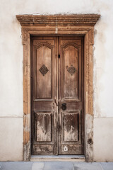 an_old_wooden_brown_door_that_has_an_ornament_