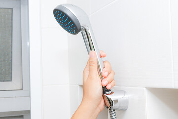 Hand hold shower head in bathroom