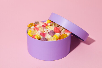 Purple box with jelly candies on pink background