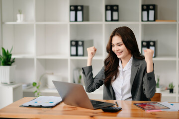 usiness woman are delighted and happy with the work they do on their tablet, laptop and taking notes at the modern office...