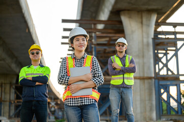 Portrait of Asian civil engineer team with architect and construction worker of industrial building on road construction site. Engineer team concept.