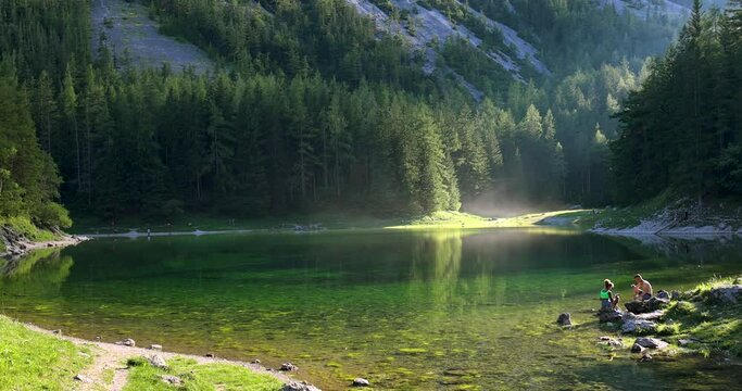 Panoramic view of the green lake in the mountains. Green algae on the surface