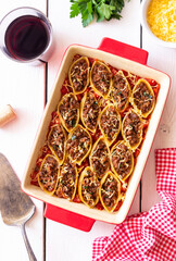 Baked pasta stuffed with meat in tomato sauce. Italian food.
