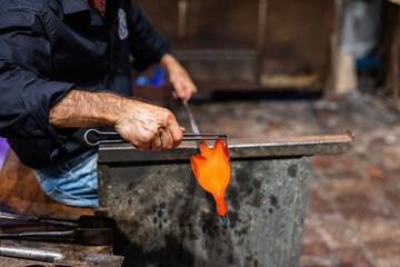 Glass blower at work in workshop in Murano, Italy