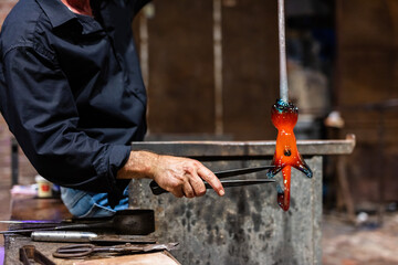 Glass blower at work in workshop in Murano, Italy
