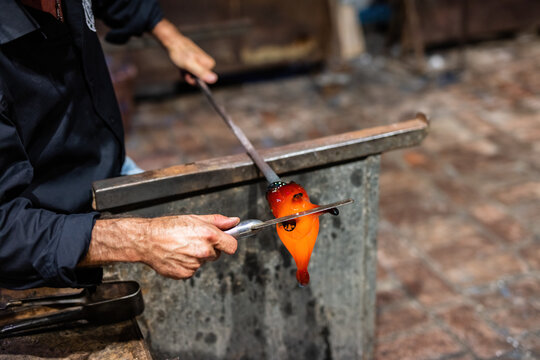 Glass blower at work in workshop in Murano, Italy