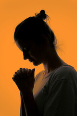 Profile Of A Woman Praying In Silhouette Isolated in Studio