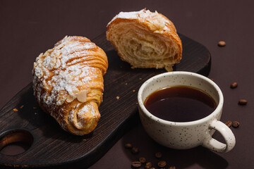 Good morning concept. Breakfast with cup of coffee and fresh croissant. Sweet creamy sauce