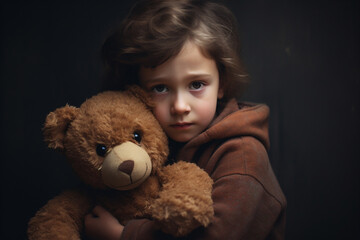 child clutching a teddy bear seeking comfort.  
