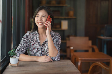 Woman herself is talking on the phone in a coffee shop.Mobile signal communication concept.