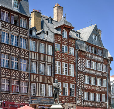 half-timbered houses and a stue of Jean Leperdit at the Place du Champ Jacquet in the breton capital city of Rennes, France