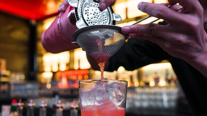 Bartender mixes ingredients to create a delightful cocktail at counter bar